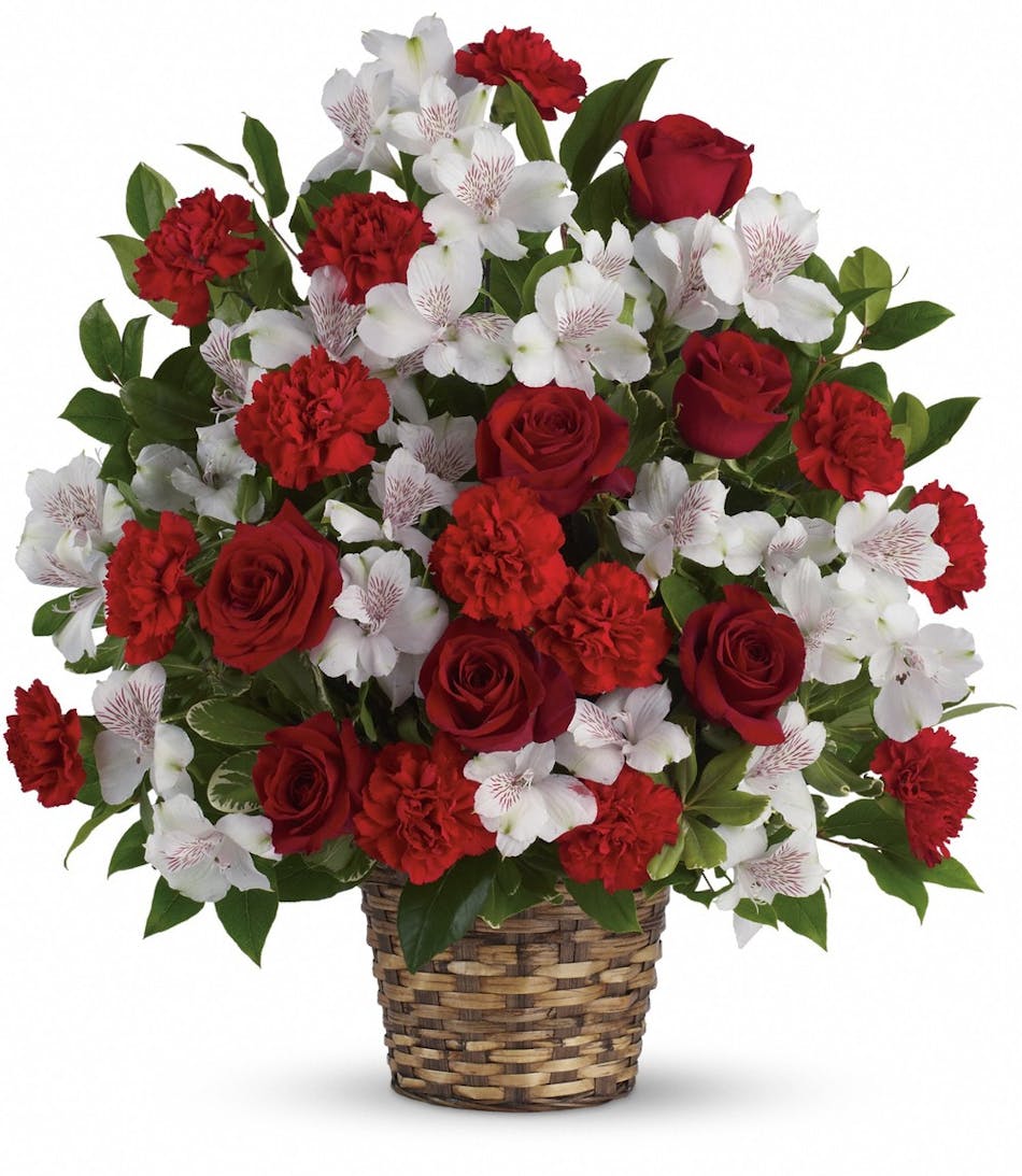 Funeral basket of red roses, white alstroemeria and red carnations with greenery. 