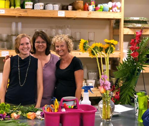 Three Julia's staff members composing an arrangement
